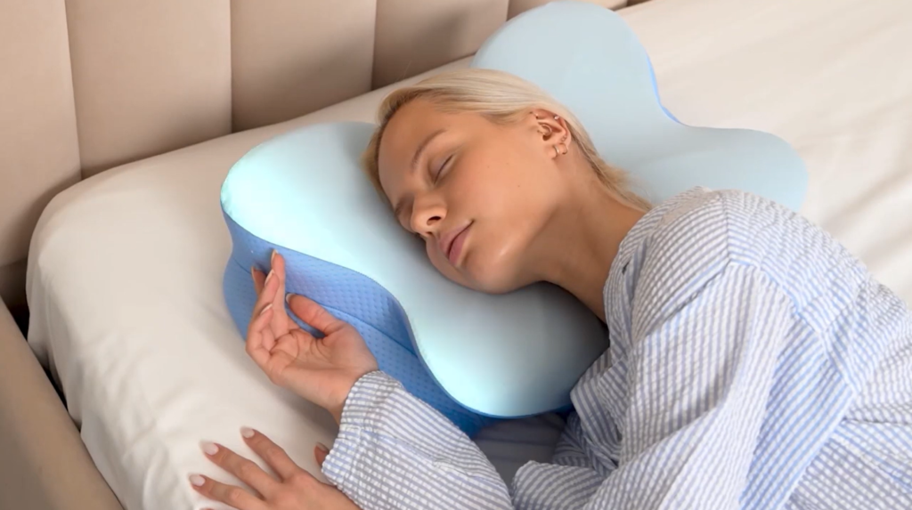 Woman resting on ergonomic pillow for more comfortable neck and shoulder support